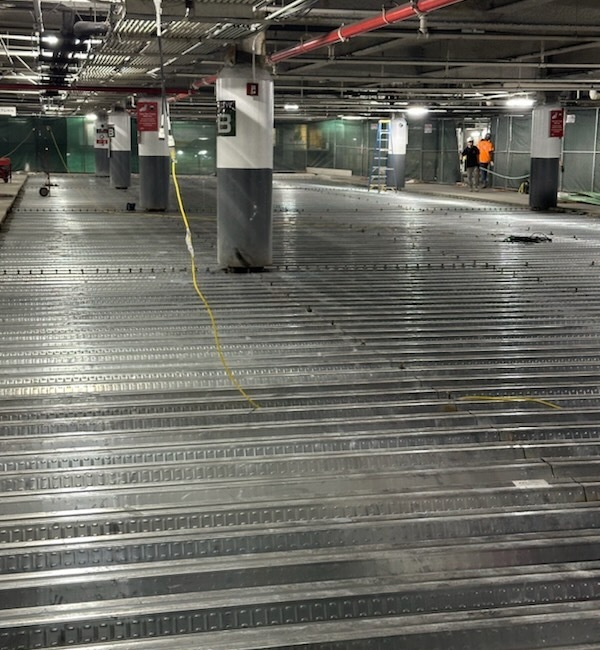 Concrete restoration for a parking garage in NYC by Malatesta Paladino, specializing in spall repair, crack injection, and rebar treatment.