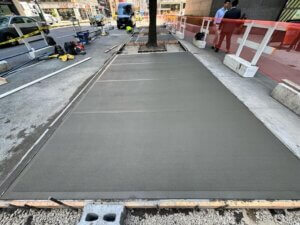 Steel-faced curb replacement in Queens by Malatesta Paladino, expert sidewalk and curb contractors in NYC.